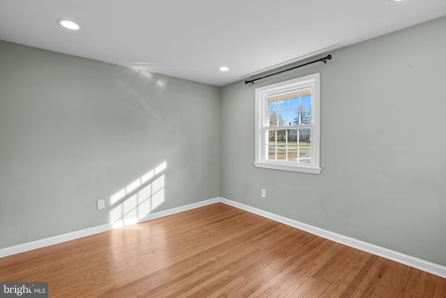 unfurnished room featuring hardwood / wood-style flooring