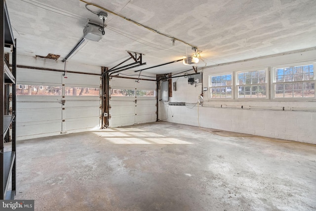 garage with a garage door opener and electric panel