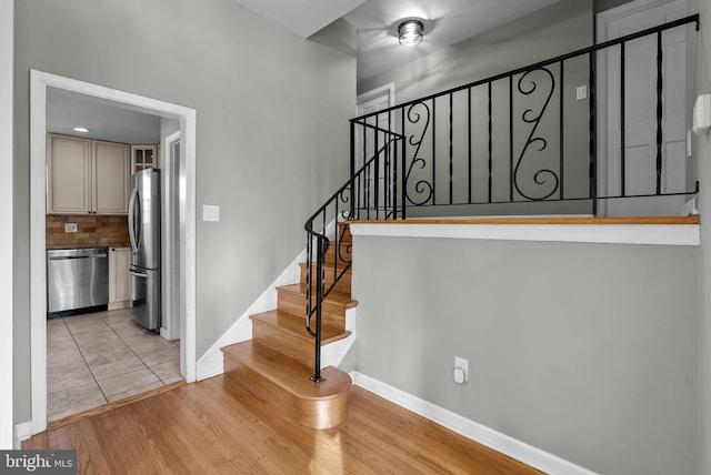 stairway featuring hardwood / wood-style floors