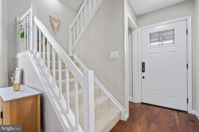 foyer with dark hardwood / wood-style floors