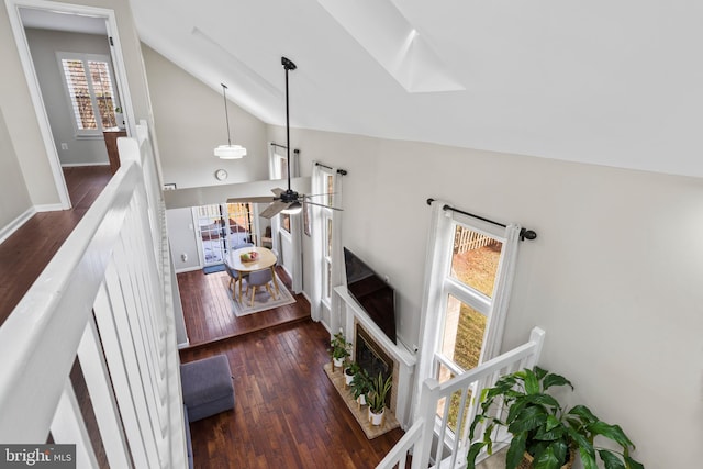 living room with vaulted ceiling, dark hardwood / wood-style floors, and ceiling fan