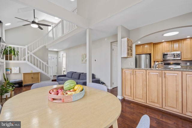 dining area with high vaulted ceiling, dark hardwood / wood-style floors, and ceiling fan