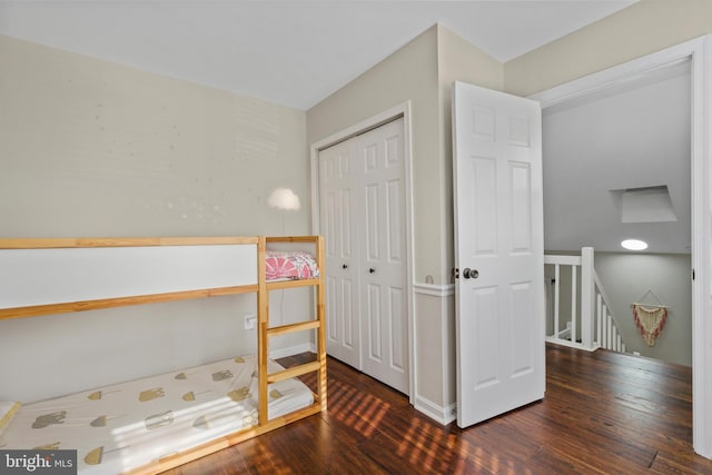 bedroom featuring dark wood-type flooring and a closet