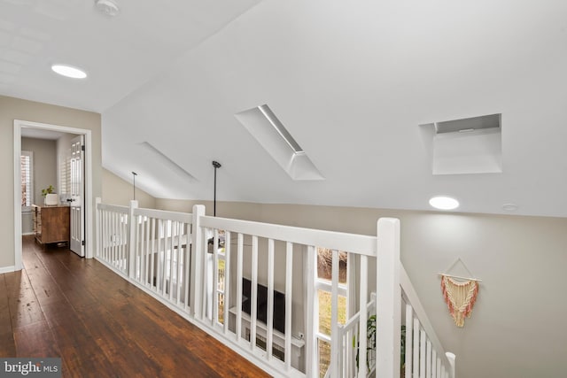 hallway with vaulted ceiling and dark hardwood / wood-style flooring