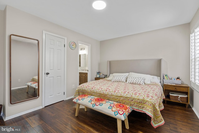 bedroom with multiple windows, dark hardwood / wood-style floors, and connected bathroom