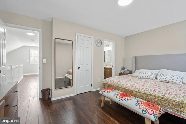 bedroom with ensuite bath, lofted ceiling, and dark hardwood / wood-style flooring