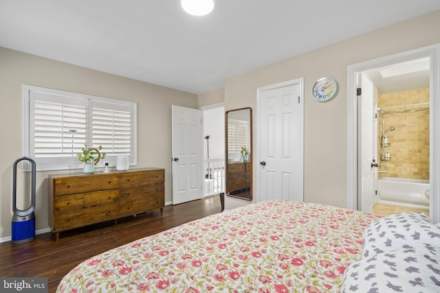 bedroom with ensuite bathroom and dark wood-type flooring