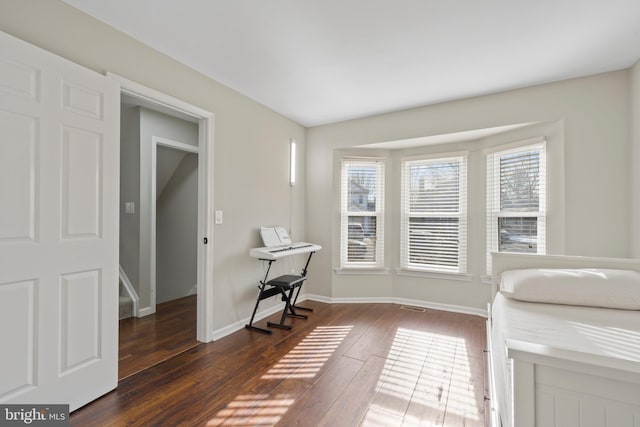 unfurnished office with dark wood-type flooring