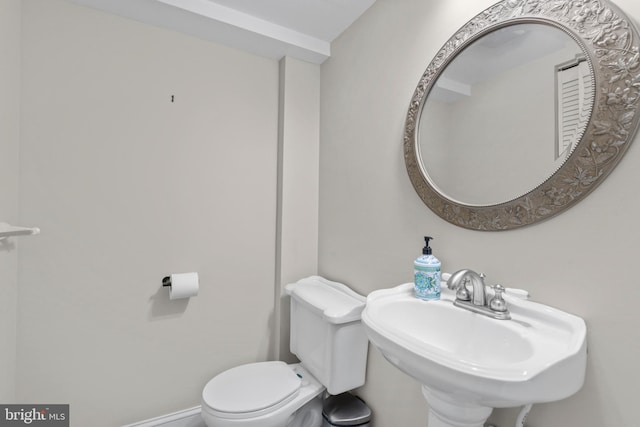 bathroom featuring sink and toilet