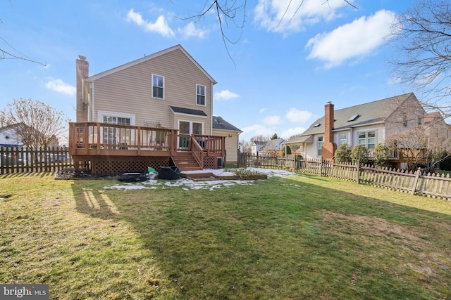 back of house with a yard and a deck