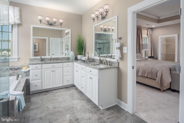 bathroom with vanity and tiled bath