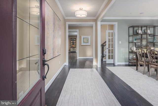 foyer with ornamental molding and dark hardwood / wood-style floors