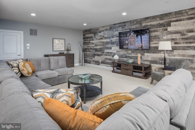 living room featuring light carpet and wood walls