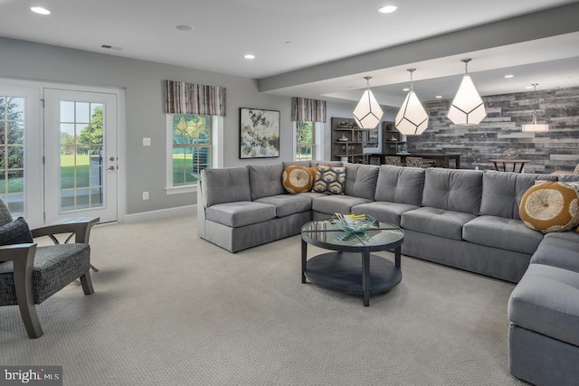 living room featuring light colored carpet and wooden walls