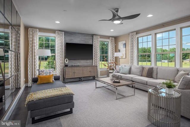 living room featuring ornamental molding, plenty of natural light, and ceiling fan