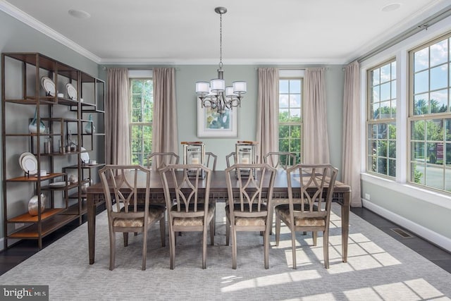 dining area with crown molding, dark hardwood / wood-style flooring, and a chandelier