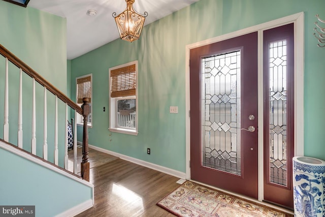 entryway with an inviting chandelier and hardwood / wood-style floors