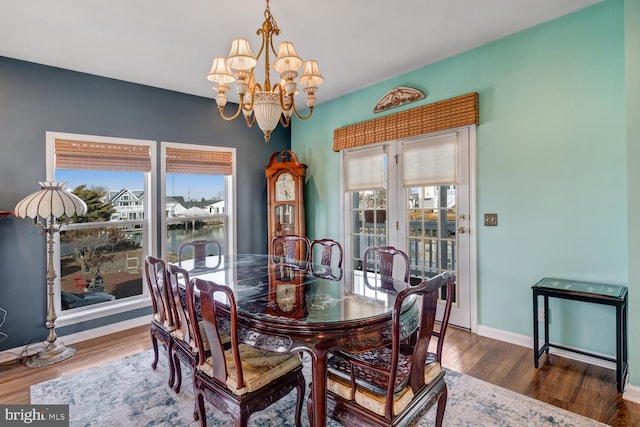 dining room featuring dark wood-type flooring and a chandelier