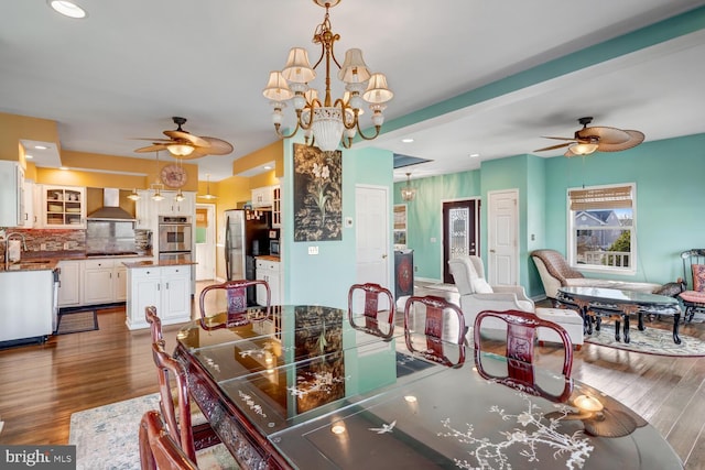 dining room with dark wood-type flooring, sink, and ceiling fan