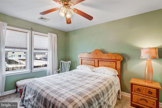 bedroom with ceiling fan and light hardwood / wood-style flooring