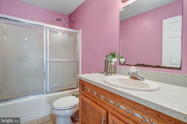 full bathroom with enclosed tub / shower combo, vanity, and toilet