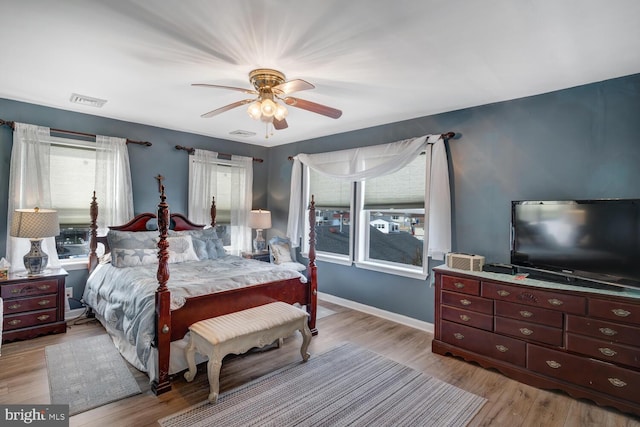 bedroom with ceiling fan and light wood-type flooring