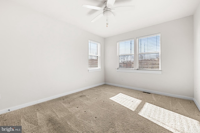 carpeted empty room featuring ceiling fan