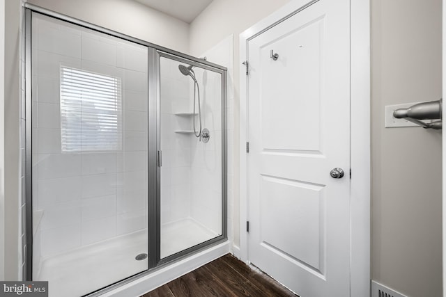 bathroom featuring hardwood / wood-style floors and walk in shower