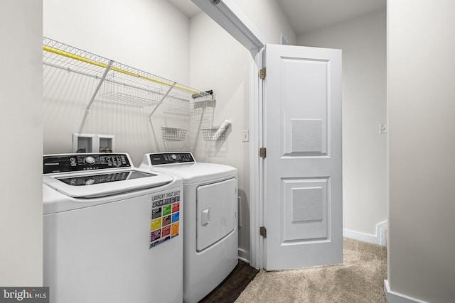 laundry room with separate washer and dryer and carpet flooring