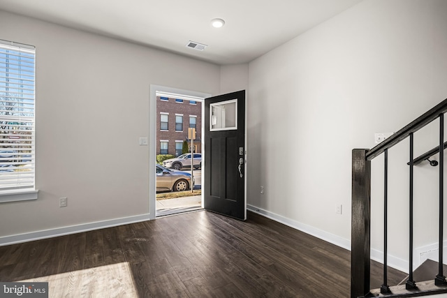 entrance foyer with plenty of natural light and dark hardwood / wood-style floors