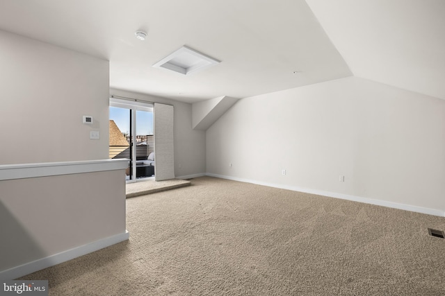 bonus room with lofted ceiling and carpet floors