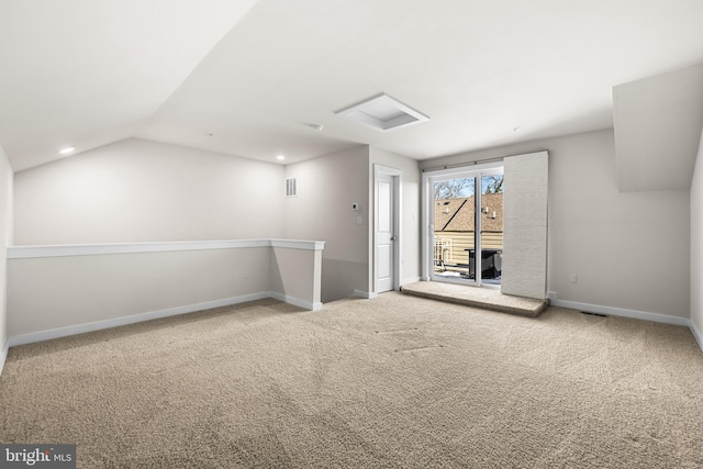 additional living space with lofted ceiling and carpet