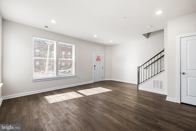 foyer entrance with dark hardwood / wood-style floors