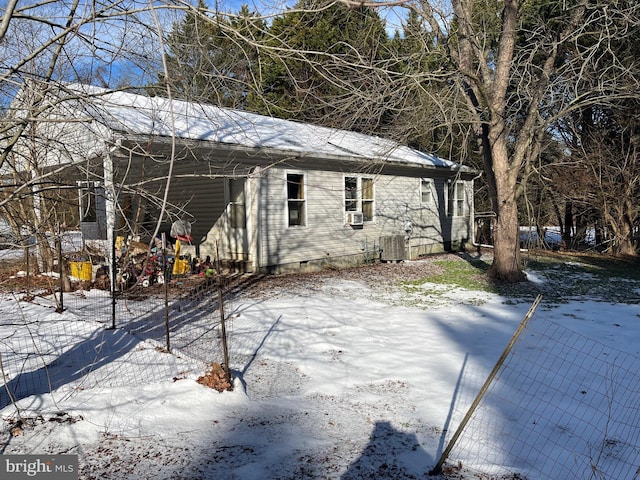 view of snow covered exterior featuring central air condition unit