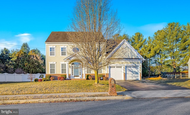 view of front facade featuring a garage and a front lawn