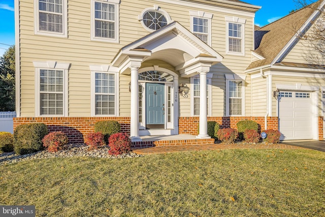 view of front facade with a garage and a front yard