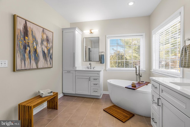 bathroom with vanity, tile patterned floors, and a bathtub