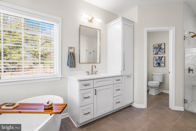 bathroom featuring walk in shower, tile patterned floors, vanity, and toilet