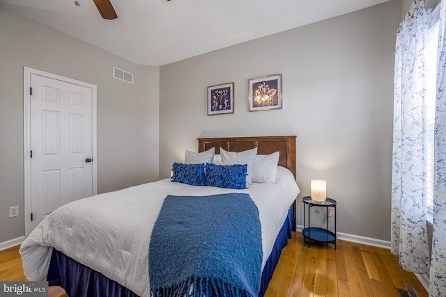 bedroom with wood-type flooring and ceiling fan