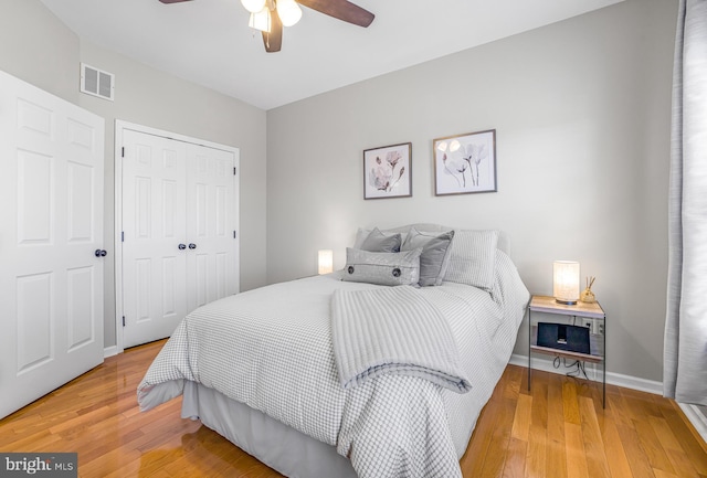 bedroom featuring ceiling fan, wood-type flooring, and a closet