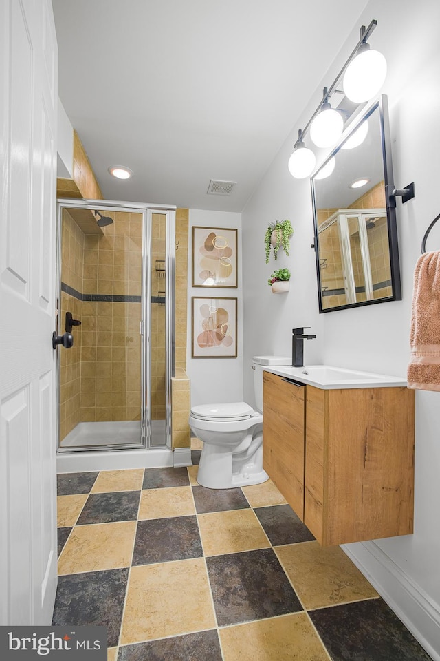 bathroom with walk in shower, vanity, and toilet