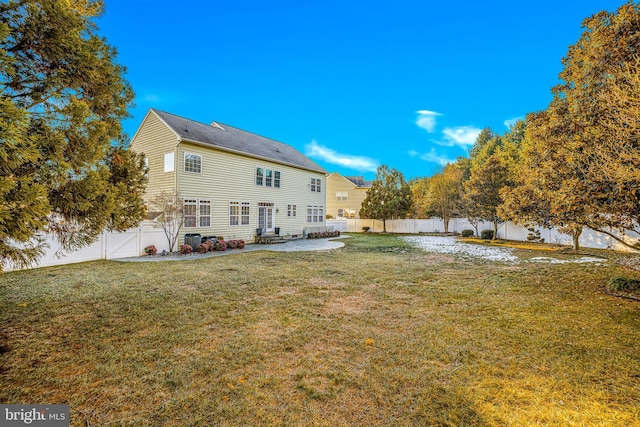 rear view of house with a yard and a patio