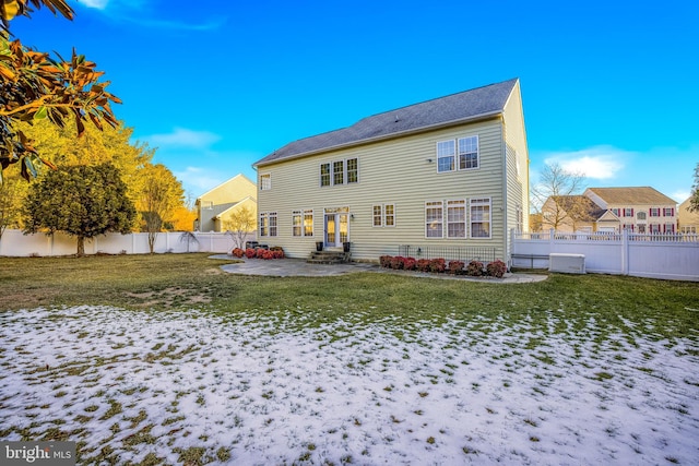 snow covered property featuring a patio and a lawn