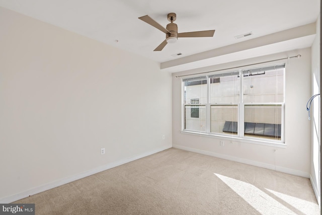 spare room with light colored carpet and ceiling fan