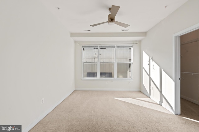 carpeted empty room with ceiling fan