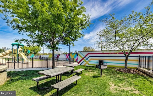 surrounding community with a yard and a playground