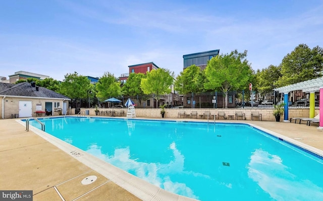 view of swimming pool with a patio and a pergola