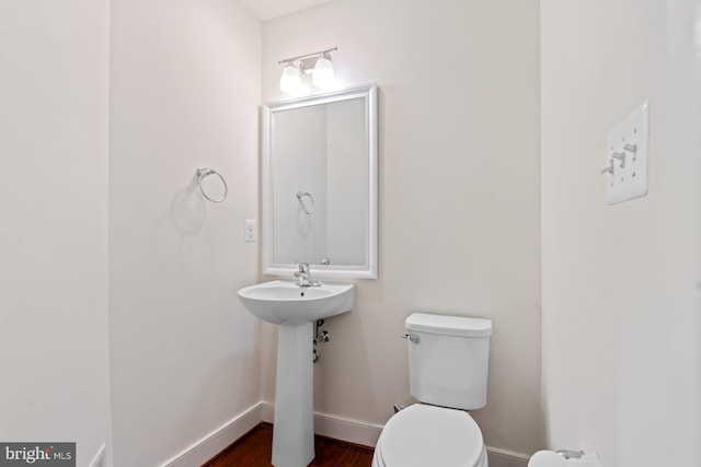 bathroom with wood-type flooring and toilet