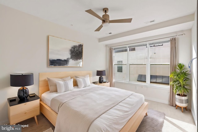 bedroom featuring light carpet and ceiling fan