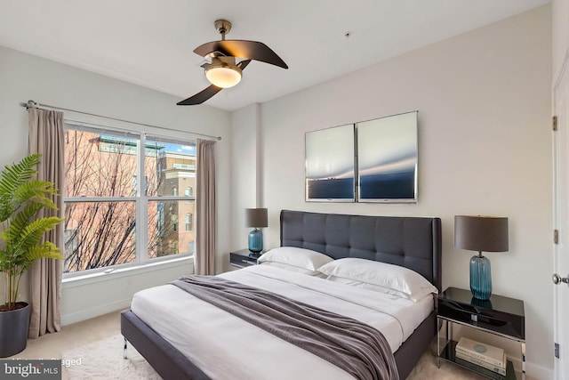 bedroom featuring light carpet and ceiling fan